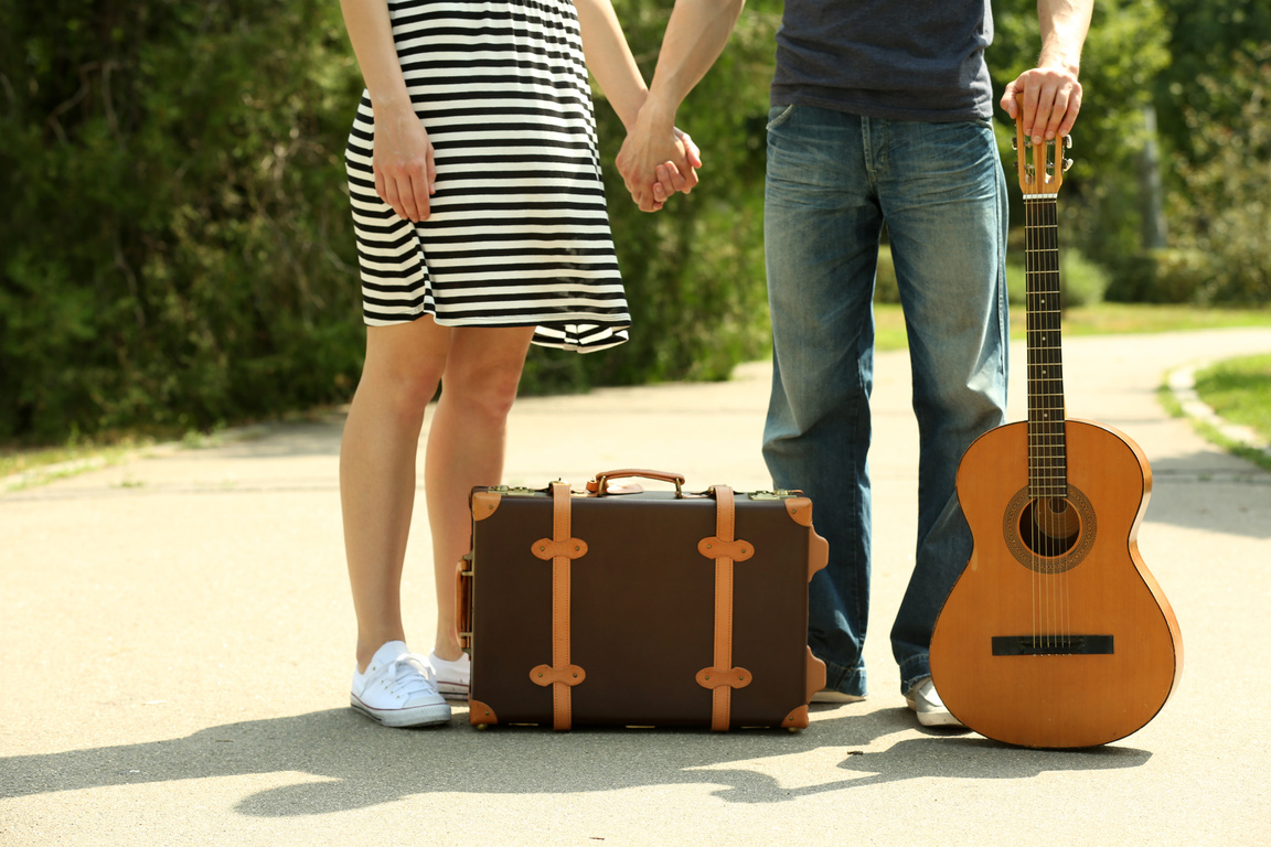 Young Couple with Vintage Suitcase and Guitar